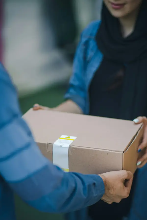 A parcel being handed from one person to another